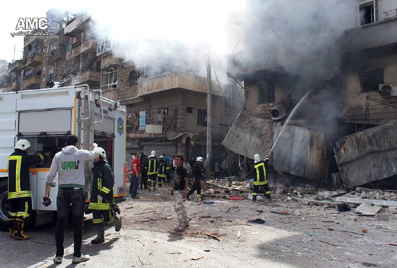 Firefighters hose down buildings after a Syrian government airstrike Friday in Aleppo. Government forces have intensified attacks on rebel bastions

