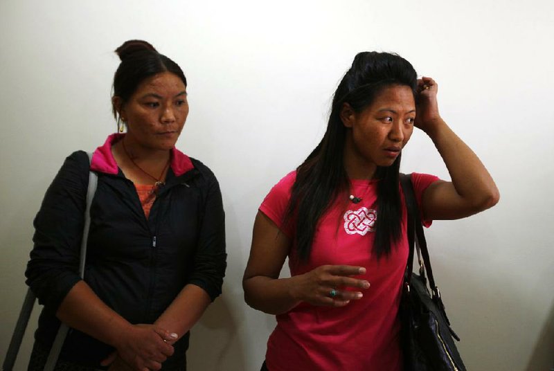 Dawa Yangzum, right, a relative of Nepalese Sherpa Dawa Tashi, who was injured during an avalanche, waits at a hospital in Katmandu, Nepal, Friday, April 18, 2014. An avalanche swept down a climbing route on Mount Everest early Friday, killing at least 12 Nepalese guides and leaving three missing in the deadliest disaster on the world's highest peak. (AP Photo/Niranjan Shrestha)