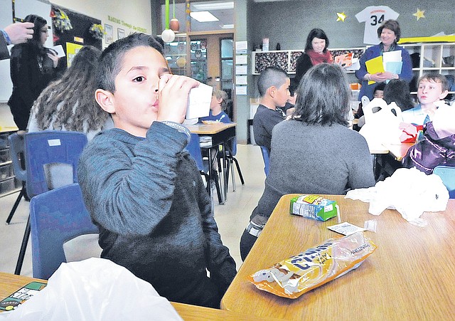 STAFF PHOTO FLIP PUTTHOFF CLASSROOM BREAKFAST Jimmy Azanza sips chocolate milk Friday that was part of his breakfast at Old Wire Road Elementary in Rogers. Breakfast is served to students in their classroom as part of the &#8220;Breakfast in the Classroom&#8221; program. Grace Hill, Bonnie Grimes, and Joe Mathias elementary schools in Rogers also serve classroom breakfast in the program paid for with a $190,000 grant from Walmart.