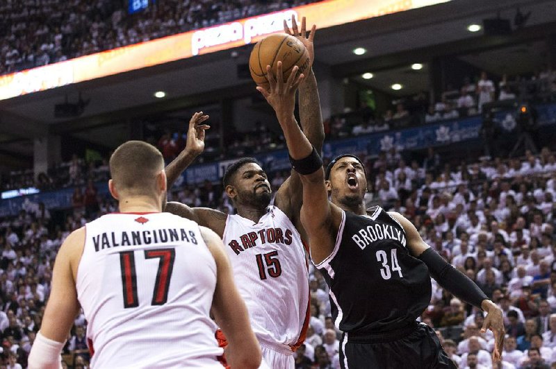 Brooklyn Nets forward Paul Pierce (34) is fouled by Toronto Raptors forward Amir Johnson (15) during the second half of their first-round NBA playoff game in Toronto on Saturday. Pierce scored 15 points and the Nets won 94-87. 