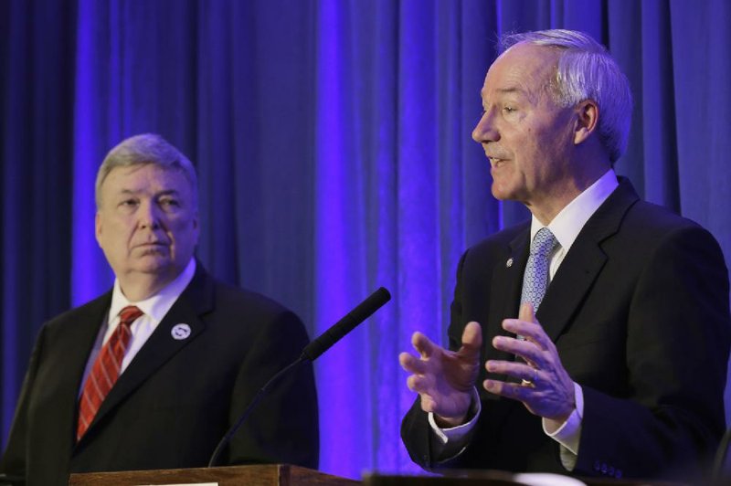 Curtis Coleman (left) shares the stage Saturday in Little Rock as Asa Hutchinson responds to a question during a debate between the two Republican hopefuls in the race for Arkansas governor. 