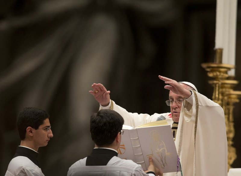 Pope Francis presides over Easter vigil services late Saturday at St. Peter’s Basilica at the Vatican. 