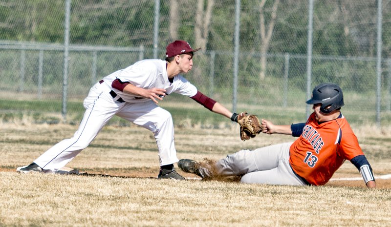 Bud Sullins/Special to Siloam Sunday Siloam Springs third baseman Dodge Pruitt tags out Rogers Heritage runner Jacob Kent during Game 1 of Tuesday&#8217;s doubleheader at James Butts Baseball Complex. The War Eagles swept the Panthers 7-0, 17-1.
