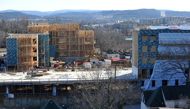 NWA Media/Michael Woods Construction crews work early this year on the Cardinal apartment complex at Duncan Avenue and Center Street in Fayetteville as The Vue apartments can be seen in the distance to the right.