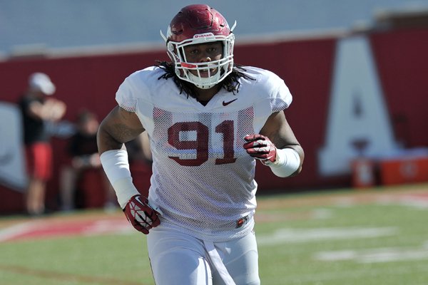 Arkansas defensive tackle Darius Philon runs drills during practice Thursday, April 10, 2014, in Fayetteville.