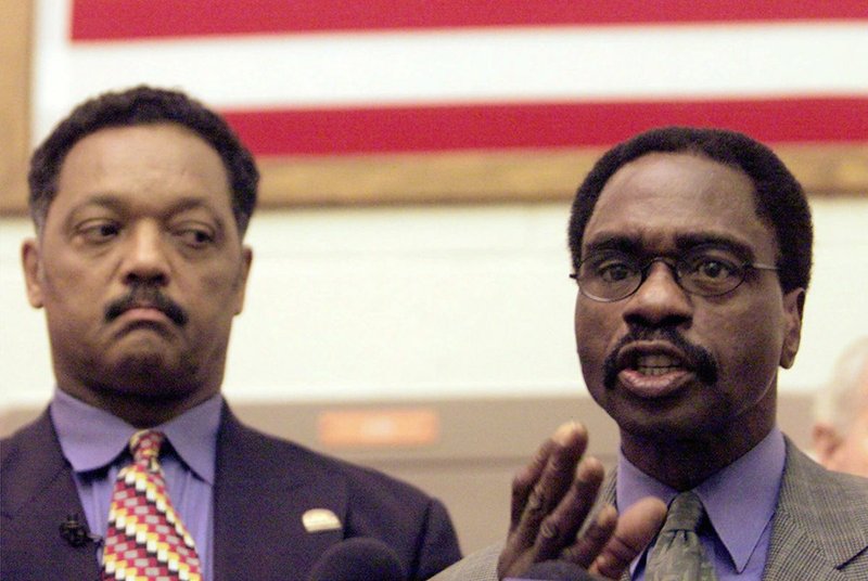 In this March 3, 2000 file photo, the Rev. Jesse Jackson, left, listens as Rubin "Hurricane" Carter, the former middleweight boxer, speaks during a news conference inside the North County Correctional Facility in Castaic, Calif. Carter, who spent almost 20 years in jail after twice being convicted of a triple murder he denied committing, died at his home in Toronto, Sunday, April 20, 2014, according to long-time friend and co-accused John Artis. He was 76.