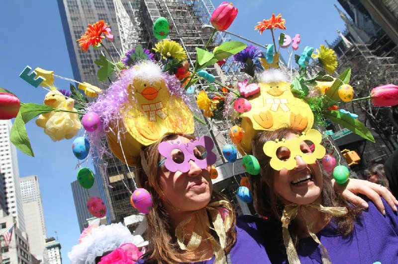 Dressed for the occasion, Paige Capala, left, and her mother Karen Zandri pose for photographs as they take part in the Easter Parade along New York's Fifth Avenue, Sunday, April 20, 2014. (AP Photo/Tina Fineberg)