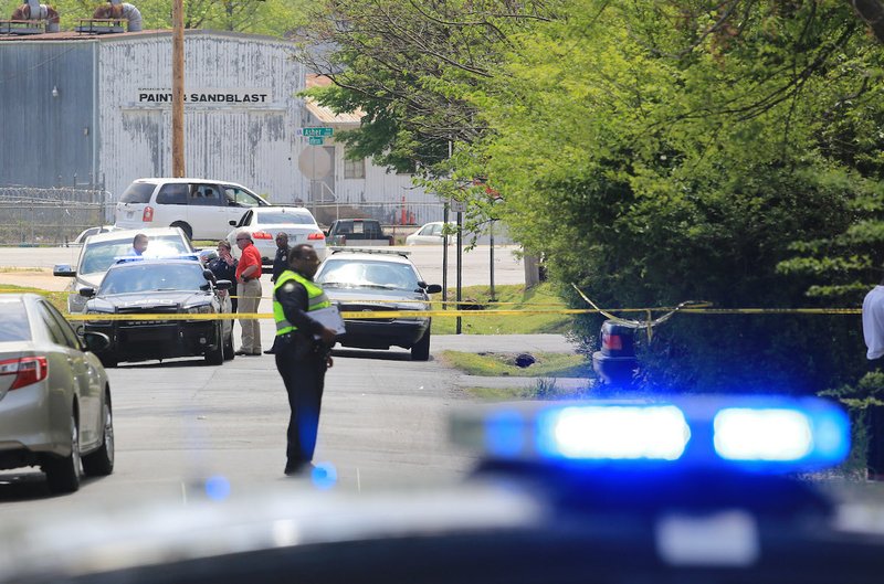 Little Rock Police officers investigate the scene of a shooting in the 3000 block of Adams St. in Little Rock Sunday. One person was shot and taken to a hospital.