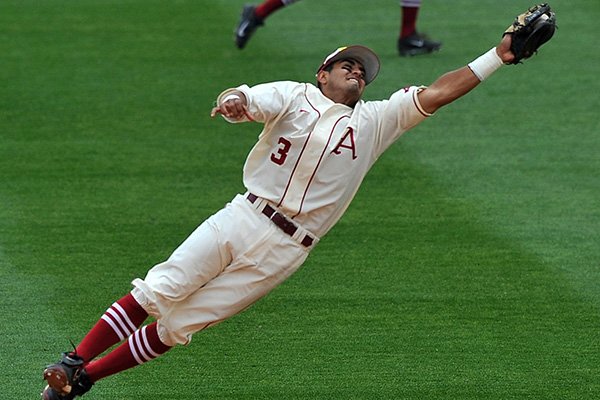 Arkansas shortstop Michael Bernal leaps to make an out on a hard hit line drive in the fifth inning of a game Sunday, April 20, 2014 against Vanderbilt at Baum Stadium in Fayetteville.