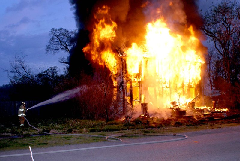 Photo by Dodie Evans A fire early Easter morning destroyed an unoccupied house on Black Avenue in Sulphur Springs. According to Sulphur Springs fire chief John Varner, the blaze was reported at about 6 a.m. when the front portion of the house was already ablaze. The fire spread rapidly engulfing almost the entire two-story structure. The home, at one time was occupied by Dr. J. H. Beard, who lived in Sulphur Springs many years. Varner was unable to verify the present owner of the structure and added the cause of the fire is still under investigation. He expressed thanks to the Gravette and Maysville fire departments for their assistance.