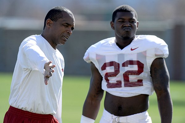 Arkansas senior associate head coach Randy Shannon directs linebacker Otha Peters during practice Thursday, March 20, 2014, at the UA practice field in Fayetteville.