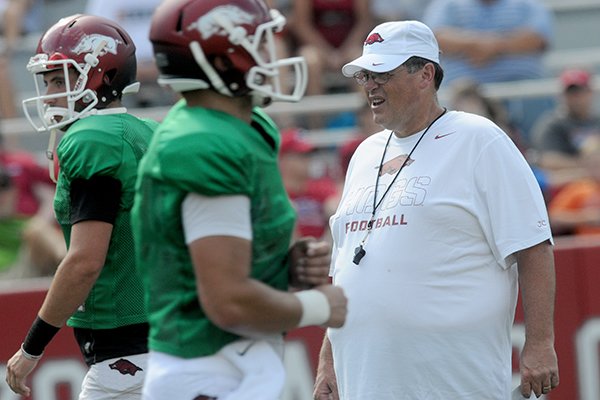 Arkansas offensive coordinator Jim Chaney, right, watches prior to a scrimmage Aug. 10, 2013 at Razorback Stadium in Fayetteville. 