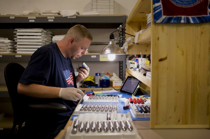 A ProVape Inc. employee works on the ProVari model assembly line in Monroe, Wash., in this June file photo. The Food and Drug Administration is expected to propose rules for the nicotine vaporizing devices as early as this month. 