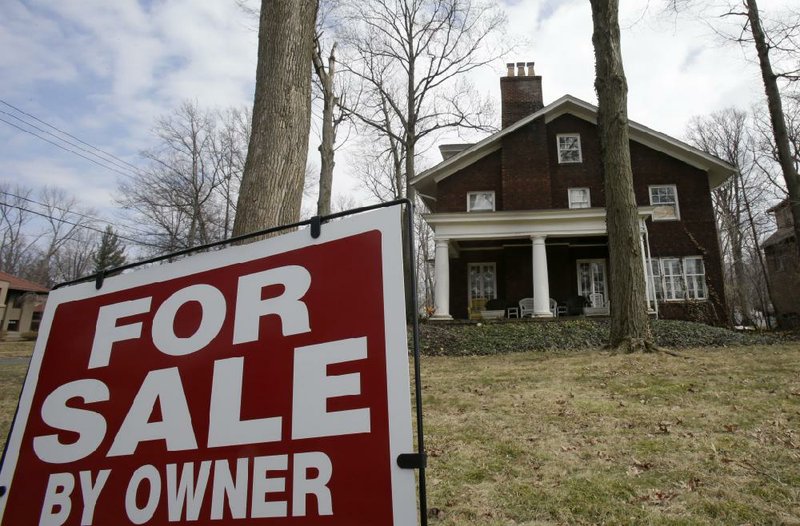 A sign marks a house for sale last month in Shaker Heights, Ohio. Sales of previously owned homes fell 0.2 percent to a seasonally adjusted annual rate of 4.59 million in March, the National Association of Realtors said Tuesday. 