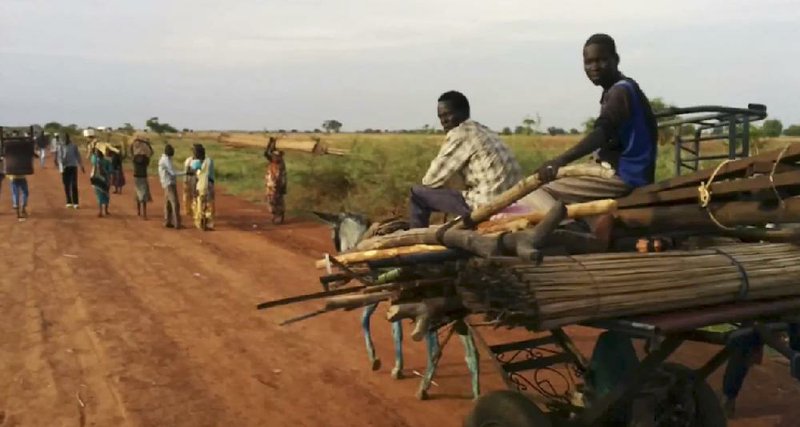 People travel on the road near Bentiu, South Sudan, on Sunday in this image taken from video. 