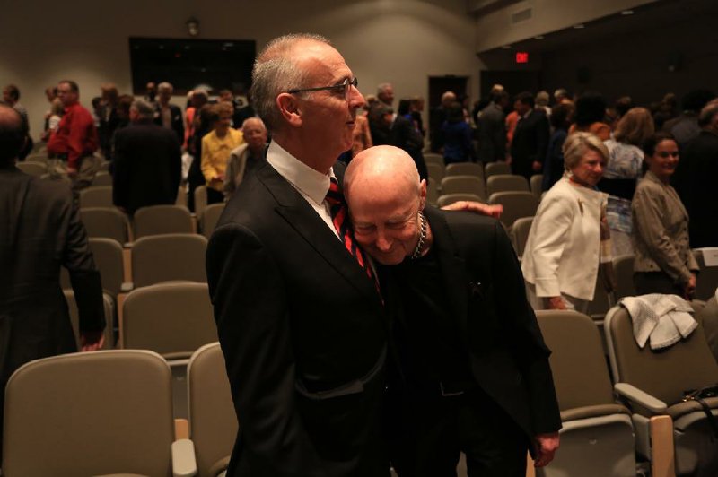 Dr. Gareth Morgan (left), named Tuesday as director of the University of Arkansas for Medical Sciences’ Myeloma Institute for Research and Therapy in Little Rock, hugs the founding director, Dr. Bart Barlogie, whom Morgan is replacing. 
