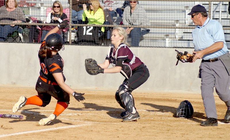 Photo by Randy Moll Lincoln catcher, Lexington Dobbs, prepares to put the tag to Gravette's Emily Miller as she attempts to score for Gravette during play in Gravette on April 15.