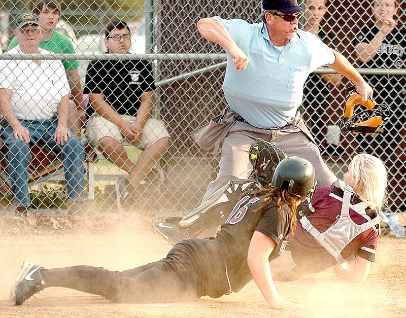 Photo by Randy Moll Lincoln catcher Lexington Dobbs tags out a Gentry runner at the plate during a nail-biter on the Lady Pioneers' home field on April 10. The game went into extra innings before Lincoln won, 8-7, and Dobbs also hit a home run.