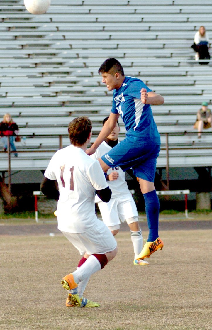 Photo by Mike Eckels Antonio Rosales, Decatur #14 bounces ball off of head toward the goal during the April 15 match with Gentry in Pioneer Stadium. Garrett Sumner, Gentry #11, tried to stop Rosales but arrived too late to prevent the play. The Bulldogs defeated the Pioneers 4 to 0.