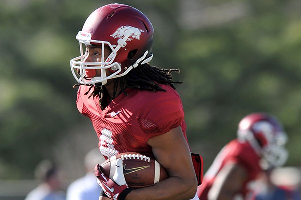 Arkansas receiver Keon Hatcher runs drills during practice Thursday, March 20, 2014 in Fayetteville.