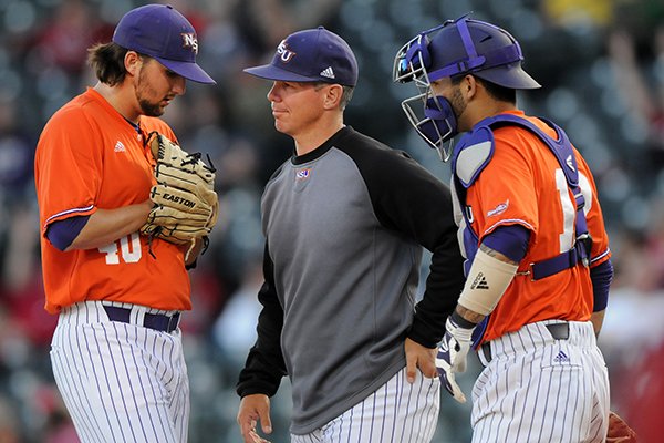 Chris Curry, center, Northwestern State pitching coach, has a chat with starting pitcher Brandon Smith, left, and catcher C.J. Webster Tuesday, April 22, 2014, during the game against Arkansas at Baum Stadium in Fayetteville.