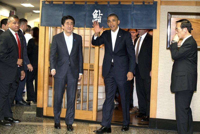 President Barack Obama and Japanese Prime Minister Shinzo Abe leave after having dinner at Sukiyabashi Jiro sushi restaurant in Tokyo on Wednesday, April 23, 2014.