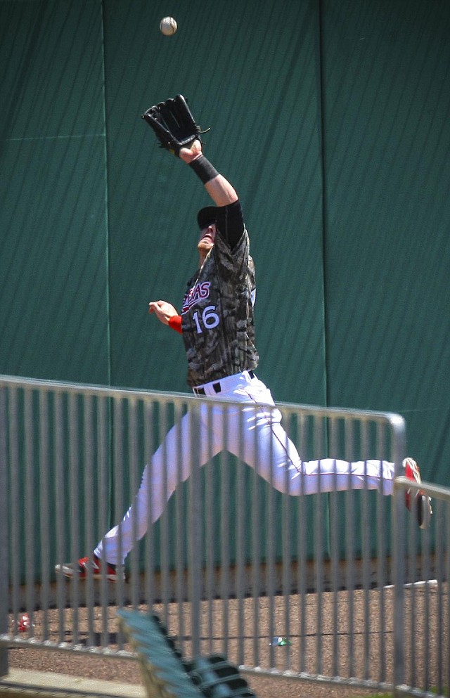 Arkansas Travelers left fielder Zach Borenstein leaps to catch a ninth-inning drive off the bat of Dustin Gorneau that Travelers starting pitcher Kramer Sneed called the play of the game. Reliever David Carpenter struck out the next two batters, preserving a 1-0 victory for Arkansas.