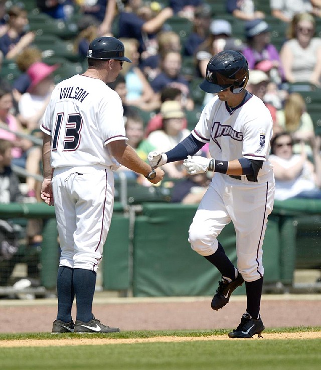 Northwest Arkansas Naturals shortstop Whit Merrifield (right) is congratulated by Manager Vance Wilson after hitting a two-run home run Wednesday against the Springfield Cardinals. 