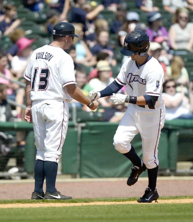 Northwest Arkansas Naturals shortstop Whit Merrifield (right) is congratulated by Manager Vance Wilson after hitting a two-run home run Wednesday against the Springfield Cardinals. 