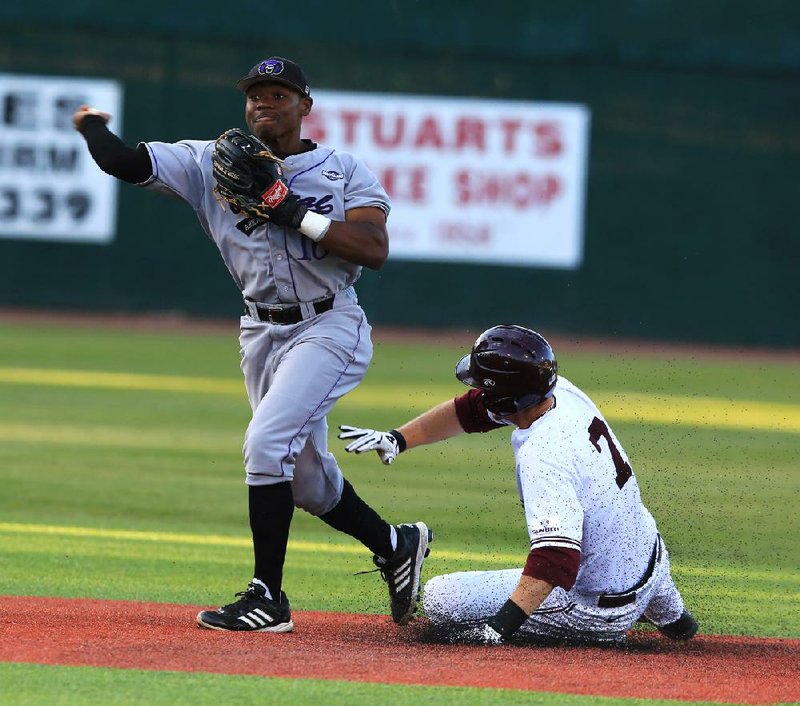 UALR’s Bryson Thionnet (7) slides into Central Arkansas second baseman Chris Townsend to break up a double play during Wednesday’s game at Gary Hogan Field in Little Rock. 