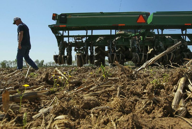 Farmer Jason Cook prepares to plant soybeans Wednesday in a field near Lonoke. Rainfall has slowed planting in Arkansas this spring. 