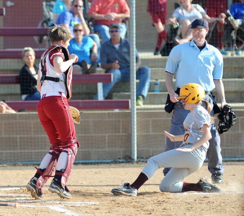 The Sentinel-Record/Mara Kuhn SLIDING SAFELY: Lake Hamilton’s McKenna Sisson scores as Texarkana catcher Morgan White looks on during Wednesday’s conference softball game on the Lady Wolves’ field.