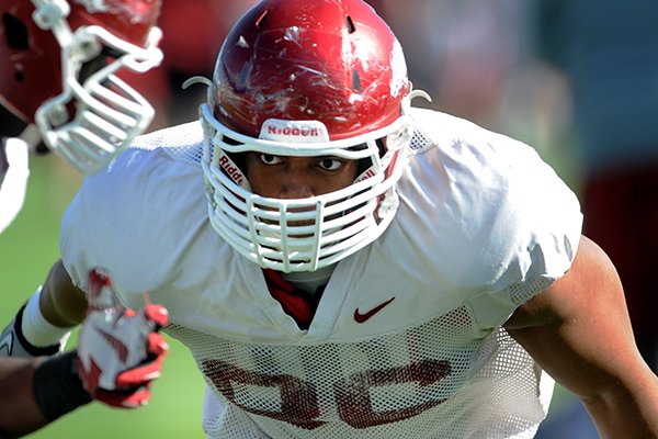 Arkansas defensive end Trey Flowers runs through a drill during practice Tuesday, April 22, 2014 in Fayetteville. 