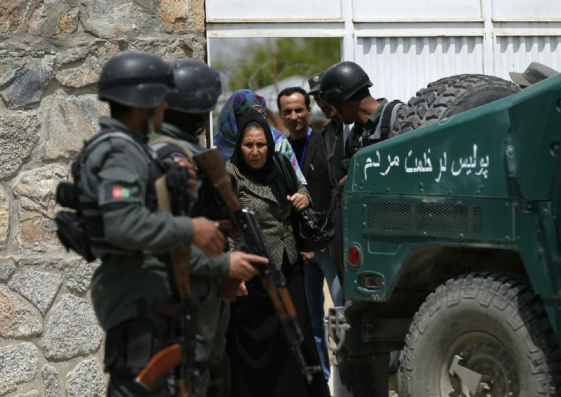 Women leave the Cure Hospital after three foreigners were killed in Kabul April 24, 2014. Three foreigners were killed on Thursday when a security guard opened fire at Cure Hospital, an international hospital, in the Afghan capital,Kabul, security sources said, in the latest of a series of attacks against foreign civilians. REUTERS/Mohammad Ismail (AFGHANISTAN - Tags: CIVIL UNREST HEALTH)