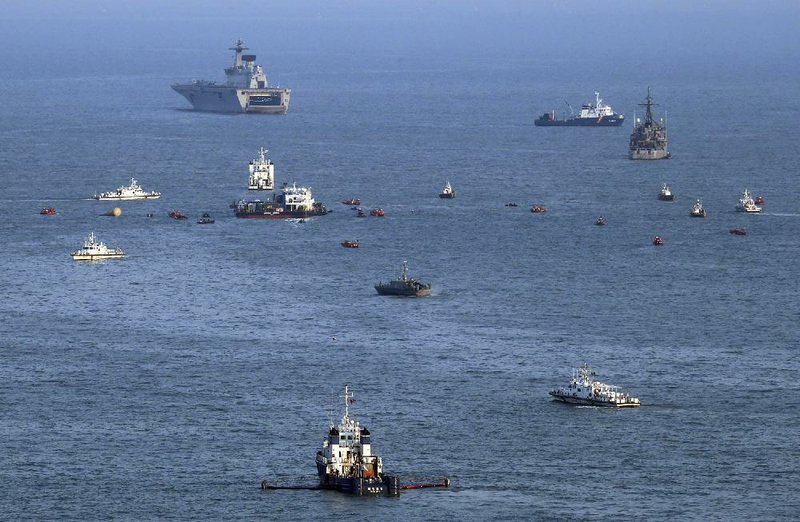 South Korean ships search the area off the southern coast where buoys mark the site of the sunken Sewol. 