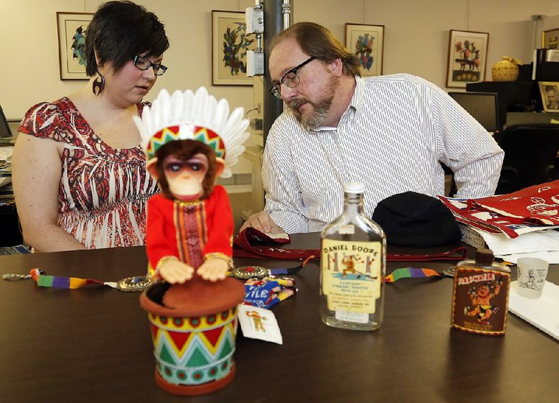 Tony Rose, project coordinator at Sequoyah National Research Center at the University of Arkansas at Little Rock, and archivist Erin Fehr display some of the artifacts collected for the center’s collection of American Indian stereotypes. 