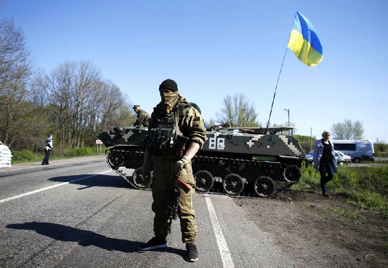 A pro-Russian militiaman guards a barricade near the state security-services building Friday in Slovyansk, Ukraine. 