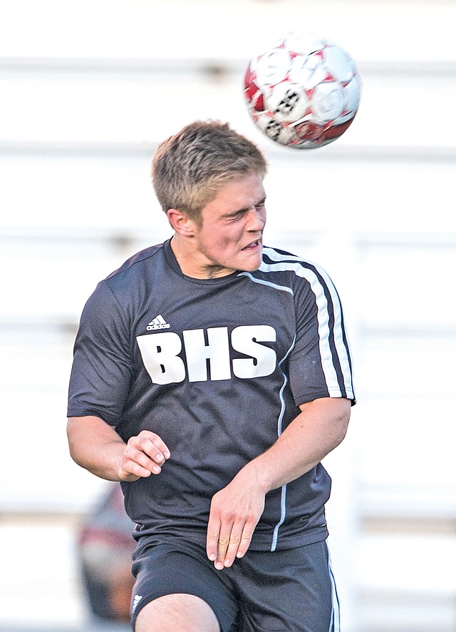  STAFF PHOTO ANTHONY REYES Bennett Moehring, Bentonville junior, heads the ball against Springdale on Friday at Bulldog Stadium in Springdale.