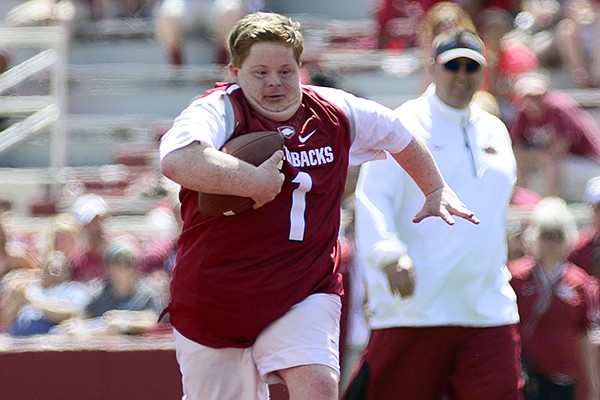 Arkansas Razorback fan Canaan Sandy scored a touchdown on a play during the Razorbacks spring NCAA college football game, Saturday, April 26, 2014, in Fayetteville, Ark. (AP Photo/Sarah Bentham)