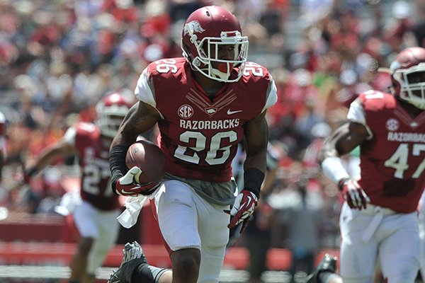 Arkansas defender Rohan Gaines returns an interception for a touchdown during the Red-White game Saturday afternoon at Razorback Stadium in Fayetteville.