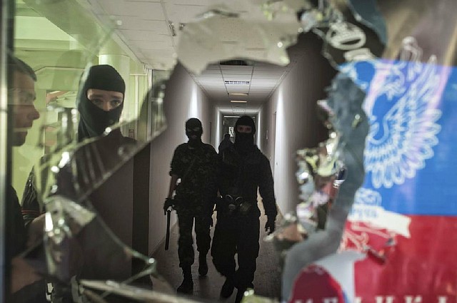 Pro-Russia militants patrol a seized government building Saturday in Mariupol, Ukraine. 