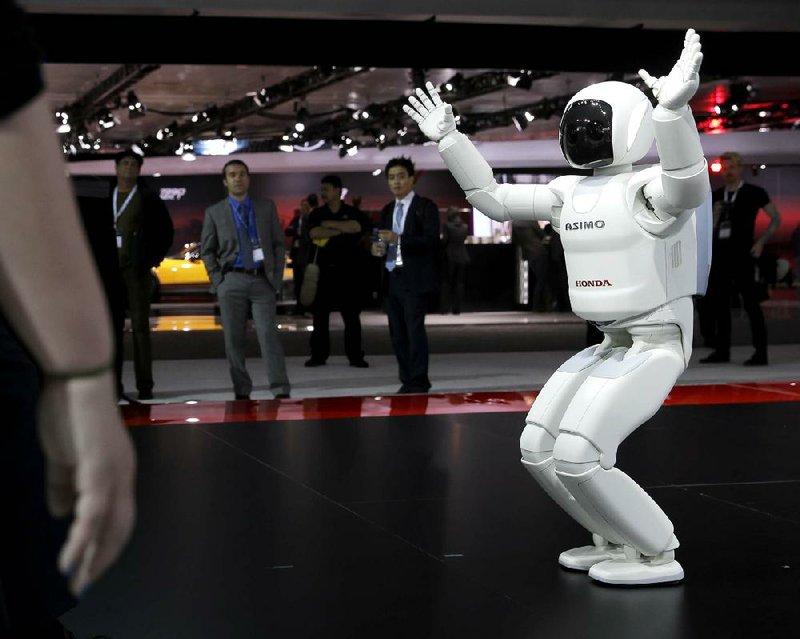 The Asimo Robot made by Honda is displayed at the New York International Auto Show in New York, Thursday, April 17, 2014.  (AP Photo/Seth Wenig)