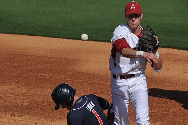 Arkansas second baseman Brian Anderson forces out Auburn baserunner Blake Logan out at second base in the second inning of the first game of Saturday's doubleheader at Baum Stadium in Fayetteville. 