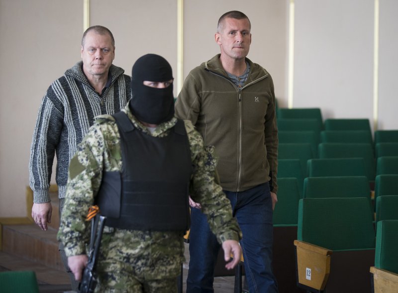 Observers held in Ukraine speak under armed guard