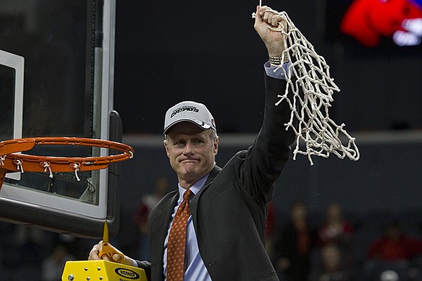 Central Missouri head basketball coach Kim Anderson acknowledges his team's fan base after cutting down the net after winning the the NCAA college Division II men's basketball championship against West Liberty in Evansville, Ind., Saturday, March 29, 2014. (AP Photo/Courier & Press, Denny Simmons)