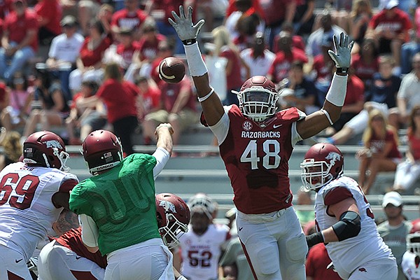 Arkansas defender Deatrich Wise Jr. puts the pressure on quarterback Austin Allen during the Red-White game Saturday afternoon at Razorback Stadium in Fayetteville.