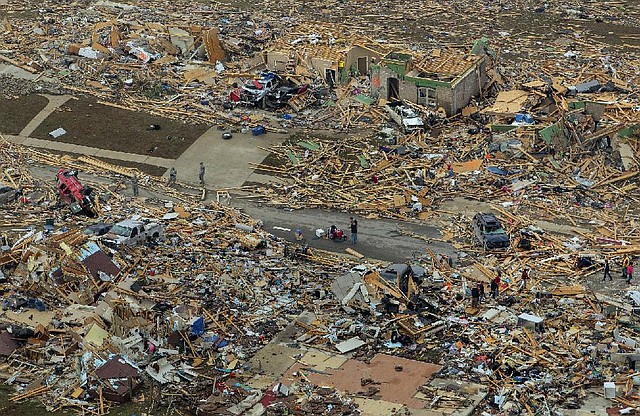 Arkansas Democrat-Gazette/BENJAMIN KRAIN --04/28/14--
Residents and rescue workers search through destroyed homes in the Park Wood Meadow neighborhood of Vilonia where several people died Sunday night during the storm.