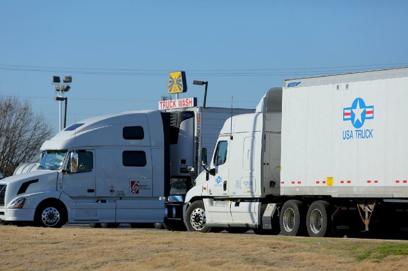 12/31/13
Arkansas Democrat-Gazette/STEPHEN B. THORNTON
A USA Truck tractor-trailer rig idles in a parking area at a North Little Rock truck stop Tuesday. 