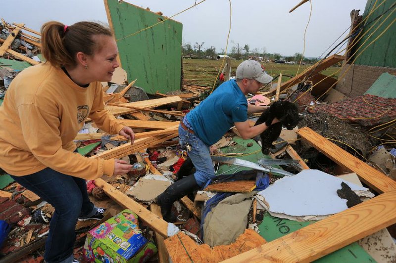 Arkansas Democrat-Gazette/RICK MCFARLAND --04/28/14--  Teela Baxter is eager to be reunited with her cat Pete after her husband Matt rescued him unharmed from underneath debris of their home Monday on Aspen Creek Dr. in Vilonia after it was destroyed by the tornado that hit the area Sunday night. The Baxters were not home at the time the tornado hit.