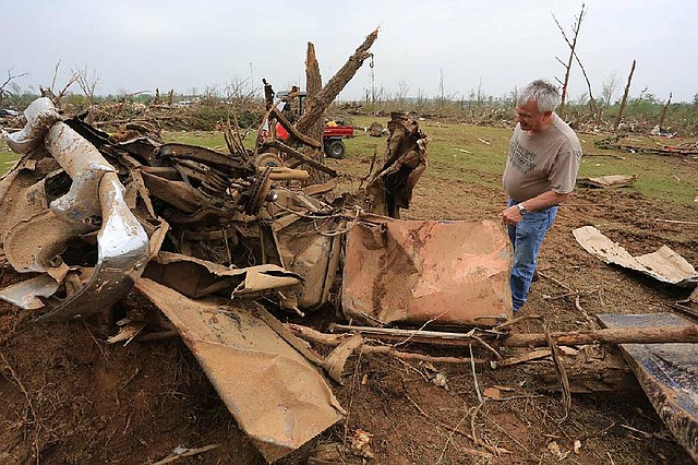 Arkansas Democrat-Gazette/RICK MCFARLAND --04/28/14--  Don Mallory, who's brother David Mallory, 58, was killed when his house was destroyed by the tornado that hit Vilonia Sunday night looks at the twisted remains of a 1955 Chevy that was one of his brother's prized posessions.